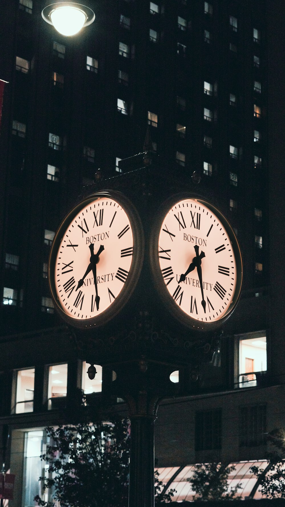 a large clock on a pole in front of a building