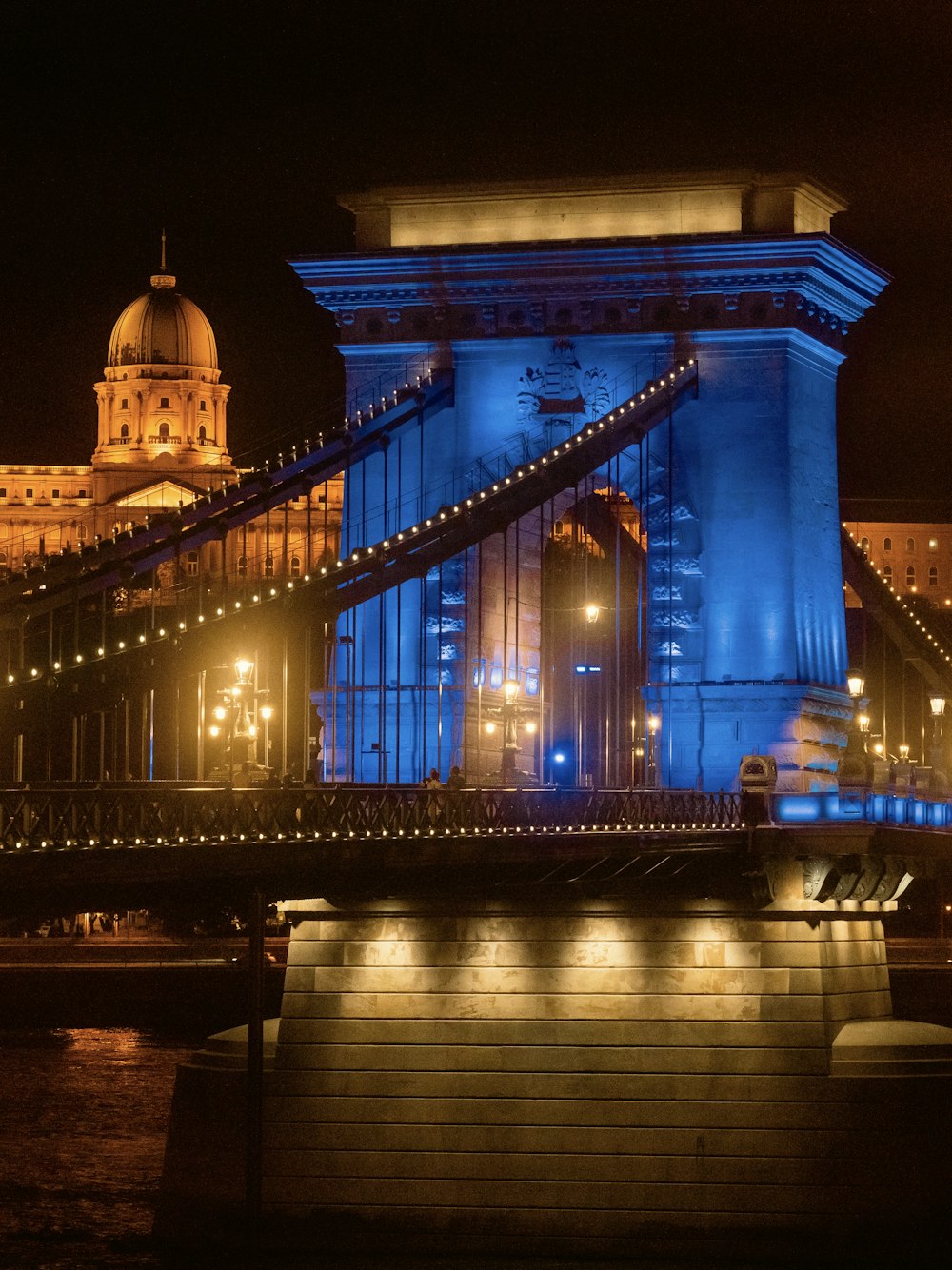 a bridge lit up with blue lights at night