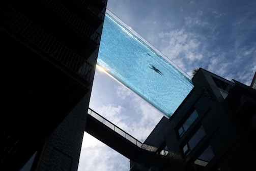 Premium glass pool structure with crystal-clear panels showcasing pool elegance.