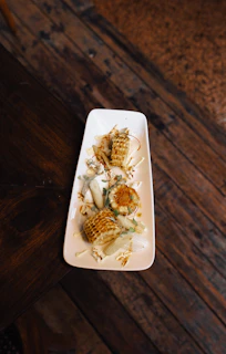 Elegant display of gluten-free corn cakes with mature cheese, styled on soft cream linen