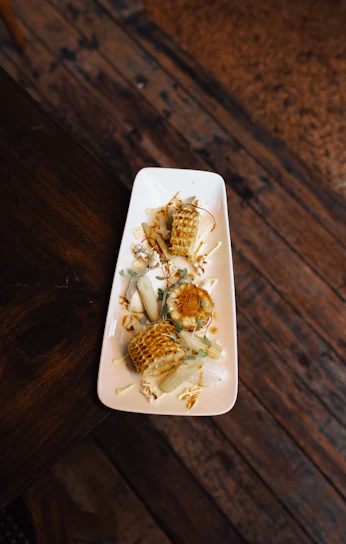 Elegant display of gluten-free corn cakes with mature cheese, styled on soft cream linen