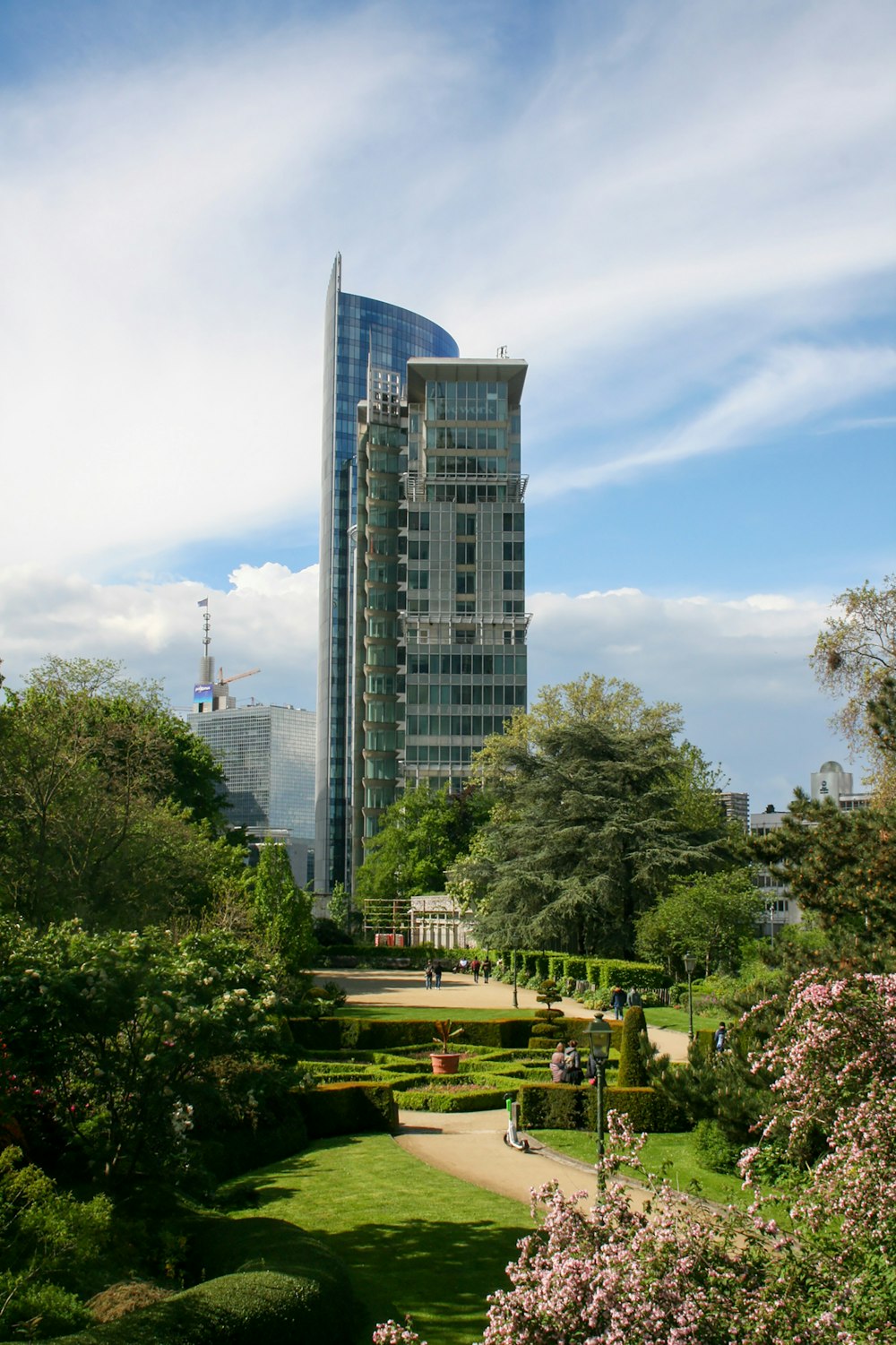 a view of a park with a tall building in the background