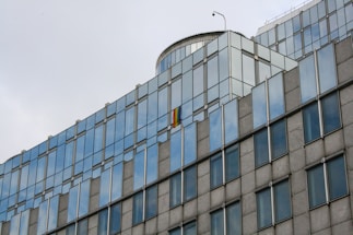 Photo of a modern London office building with the UK flag colors subtly reflected in the glass facade.