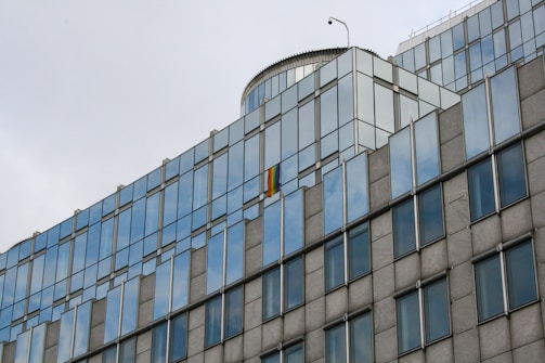 Photo of a modern London office building with the UK flag colors subtly reflected in the glass facade.