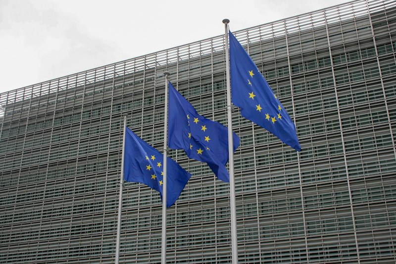 European Union flags flying in front of a government building in Brussels