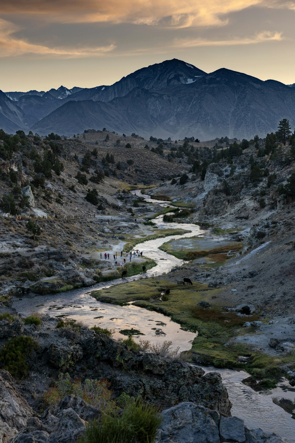 a river running through a valley surrounded by mountains