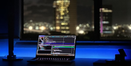 Close-up of a coder working on AI agent software with futuristic blue lighting.