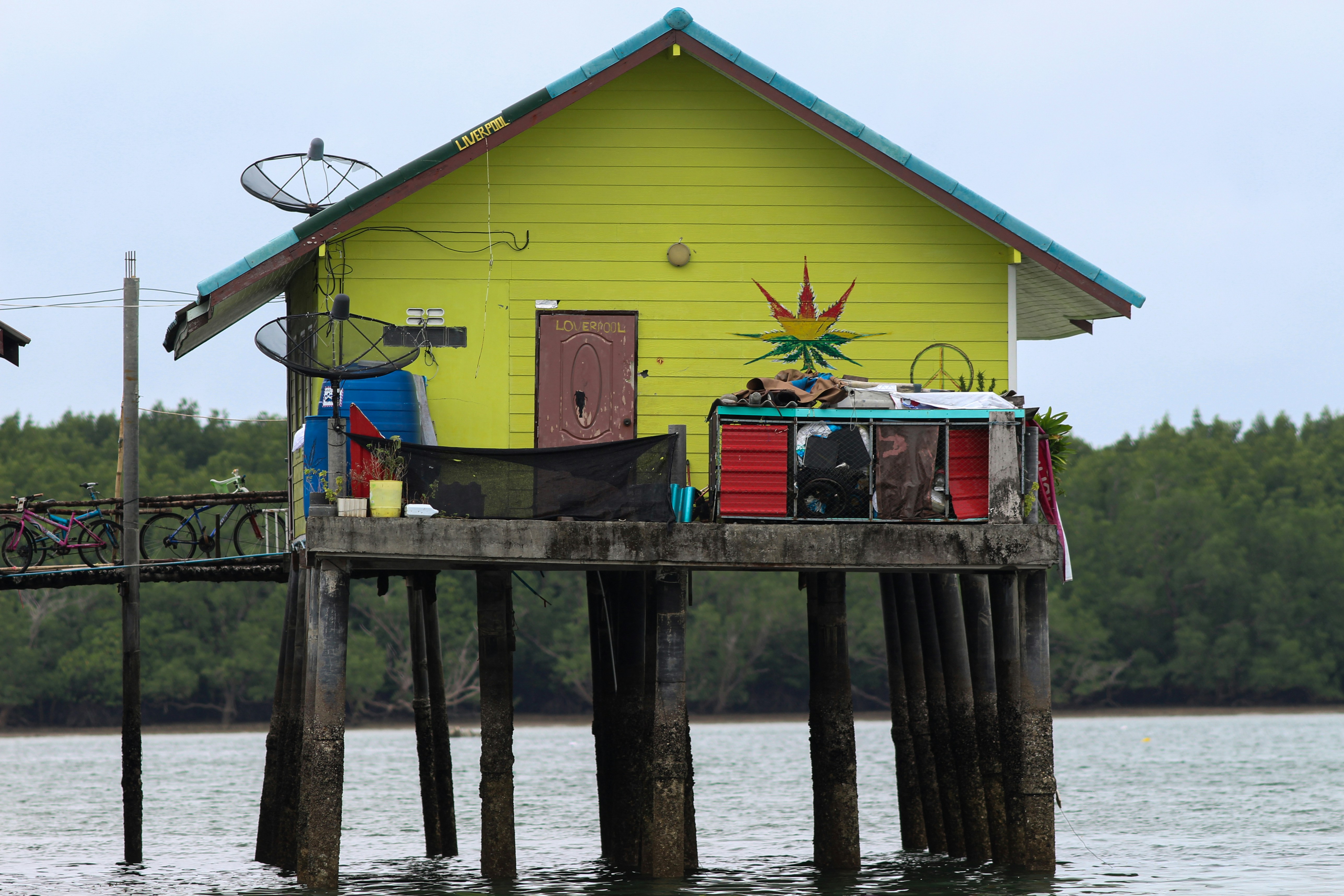 a yellow house with a bicycle on the dock