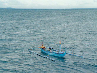 a couple of boats floating on top of a large body of water