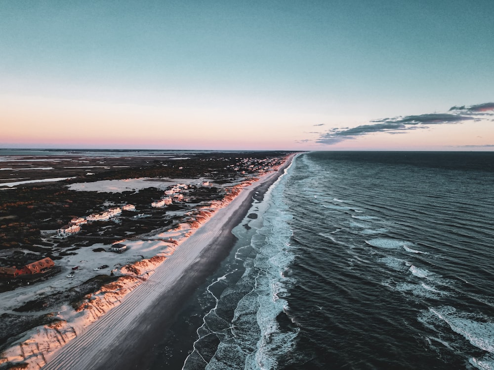 an aerial view of a beach at sunset