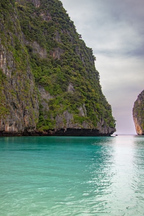 a body of water with a mountain in the background