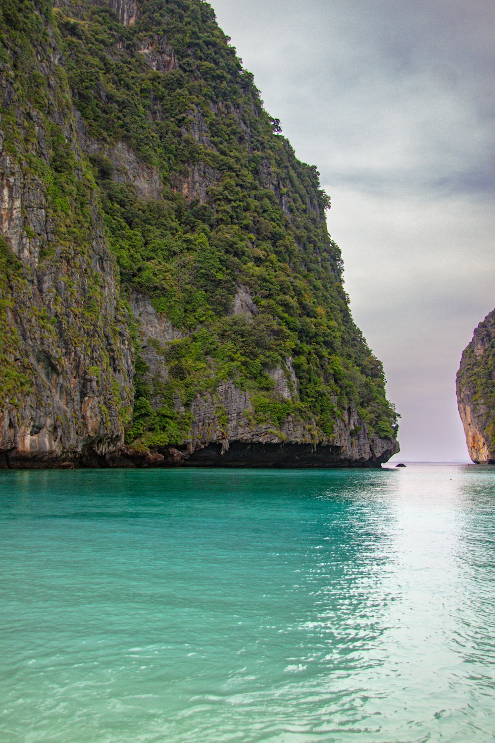 a body of water with a mountain in the background