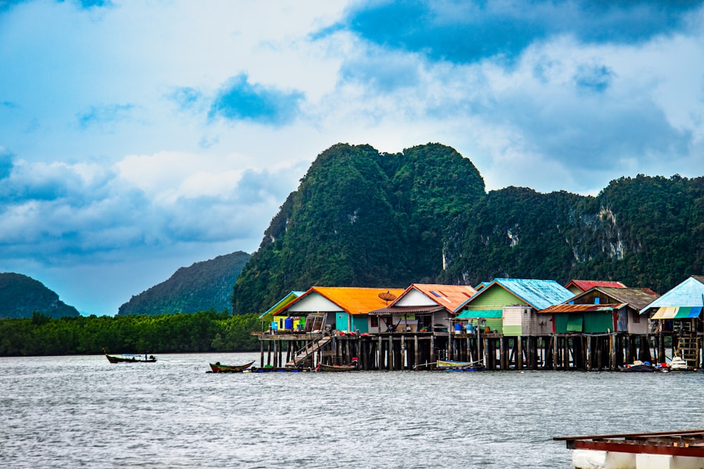 a group of houses sitting on top of a body of water