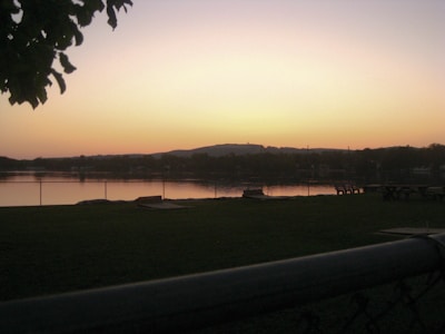 Sunset view over a calm lake with a family enjoying a picnic on the shore