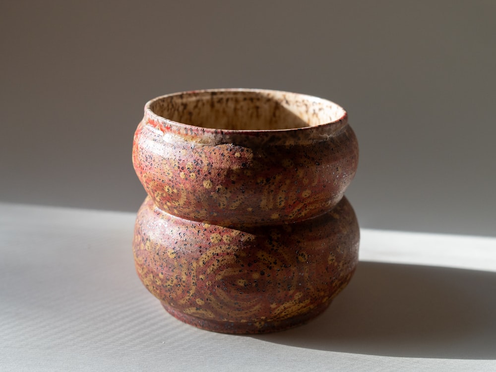 a close up of two vases on a table