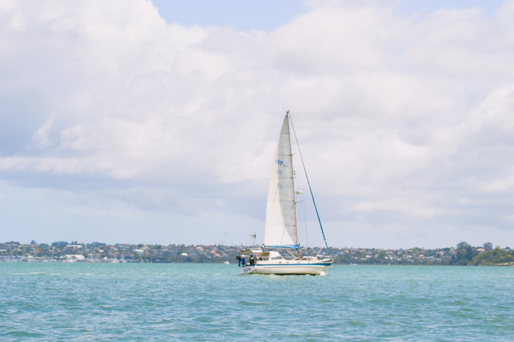 a sailboat in the middle of a body of water