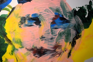 An abstract painting with swirling patterns and vibrant colors, featuring a human-like face with expressive brush strokes. The face is crafted by overlaying shades of pink with dark blue, green, and yellow accents, creating a sense of movement and depth.