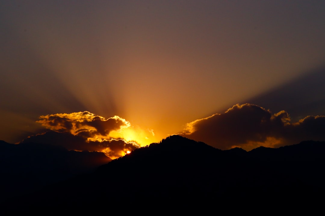 the sun is shining through the clouds in the sky,
