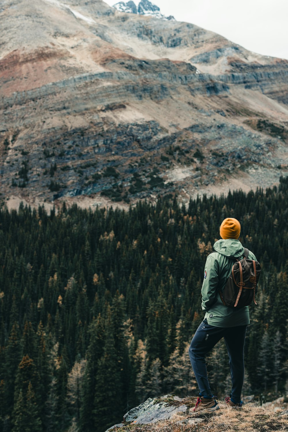 a person standing on a hill with a backpack