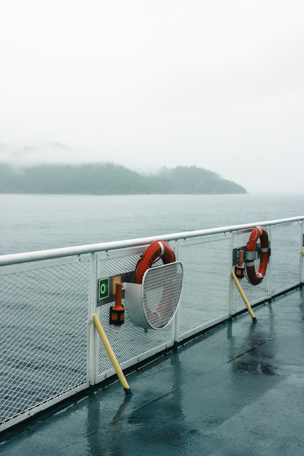 a row of life preservers on a boat on a body of water