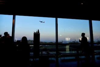 Business travelers boarding a modern airplane at sunrise.