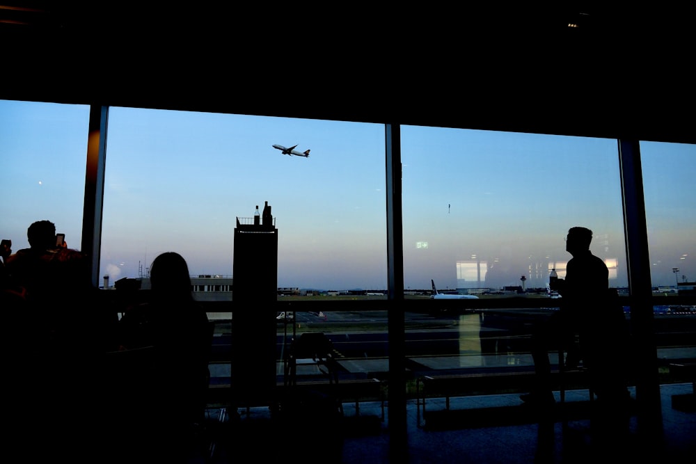 a plane is flying in the sky through a window