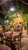 Charming outdoor dining area with string lights and rustic wooden tables