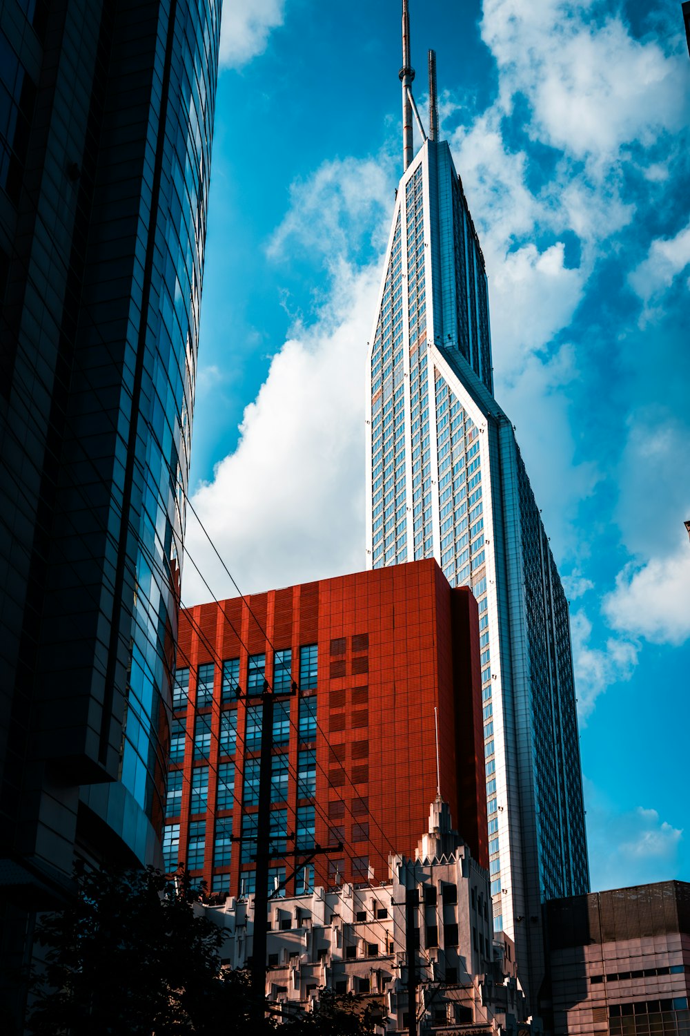 a very tall red building with a sky background