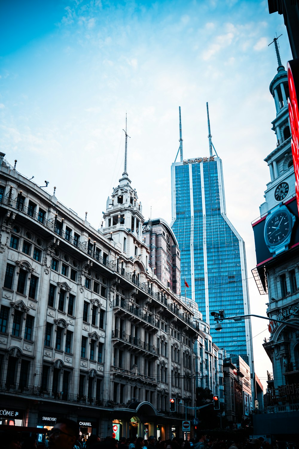 a city street with tall buildings and a clock tower