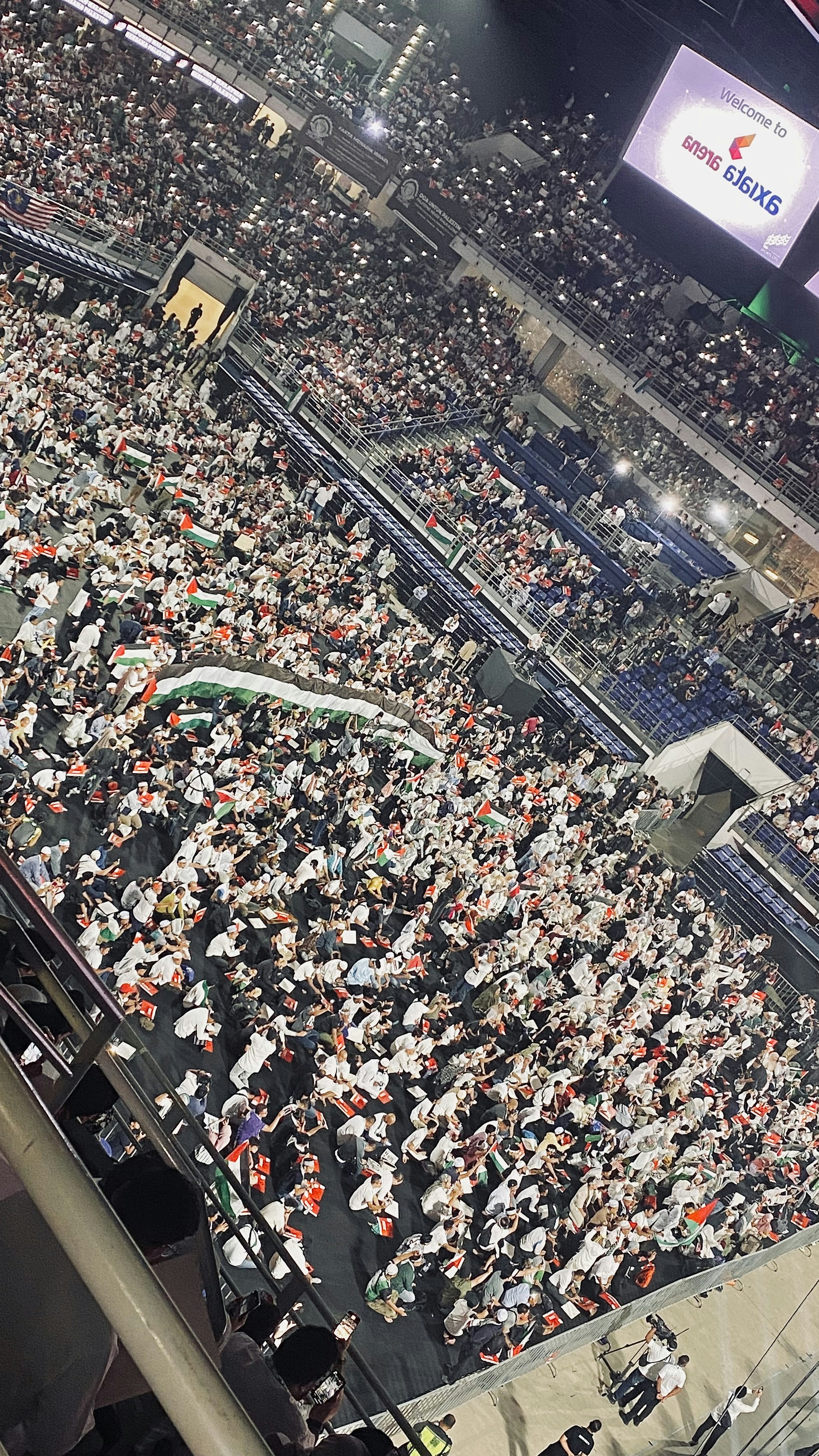 Football match replay on stadium screen with crowd celebrating