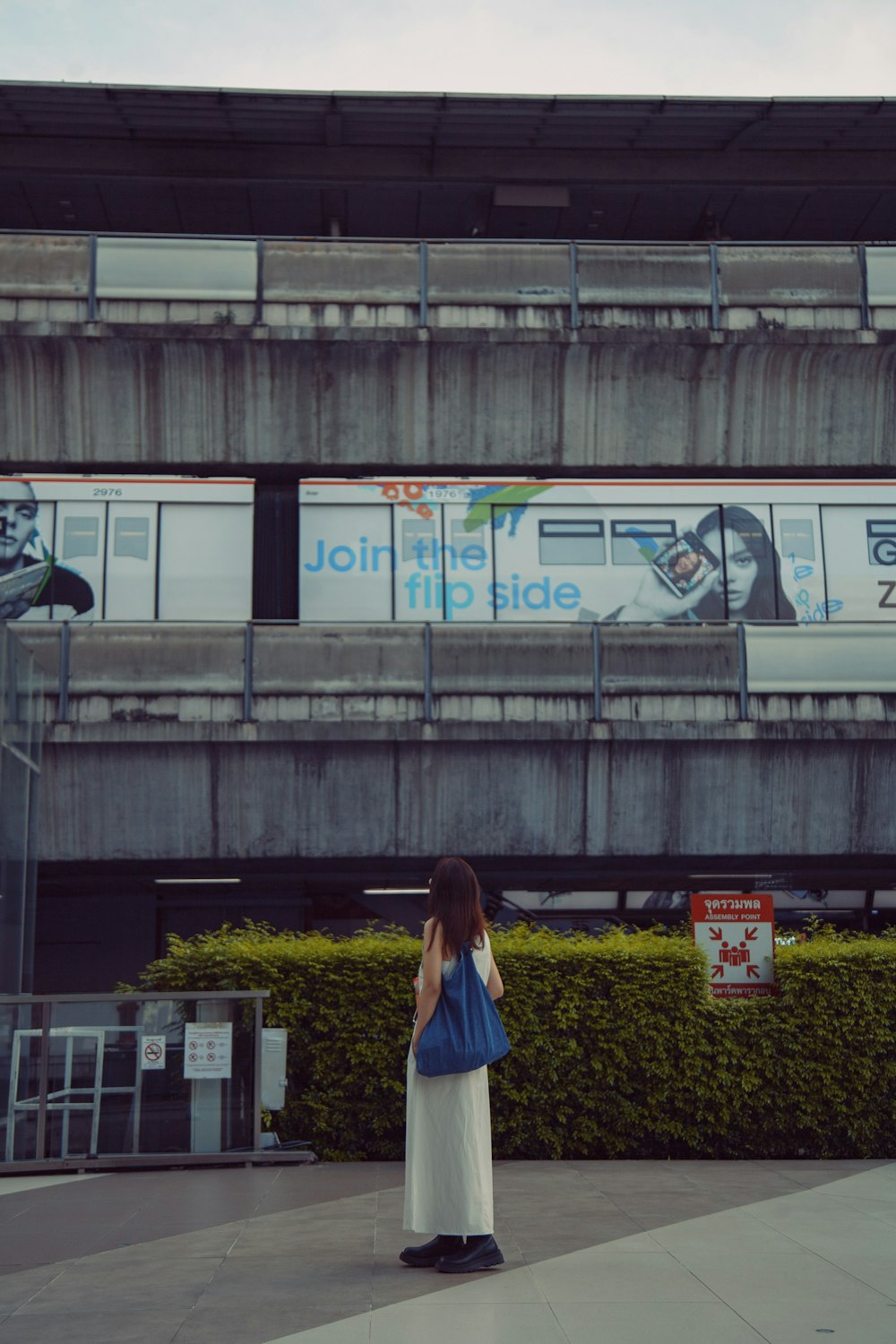 a woman standing in front of a train station