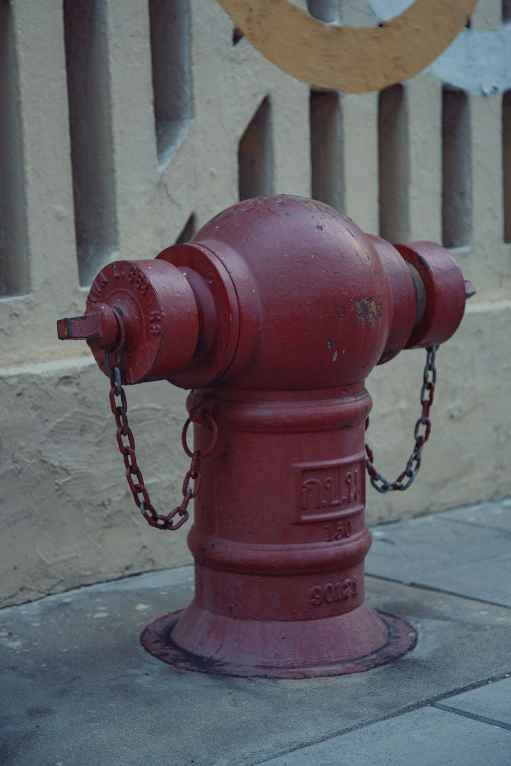 a red fire hydrant sitting on the side of a road