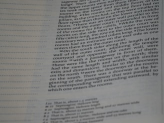 A close-up of a page from a book, with text in columns. The text is printed on an off-white background, with dotted horizontal lines in the margin. The focus is mainly on the right side of the page, which contains detailed descriptions of architectural elements.