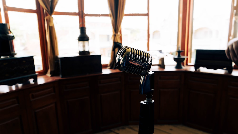 a microphone on a tripod in front of a window