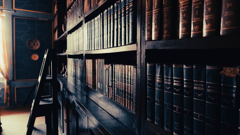 a row of books on a shelf in a library