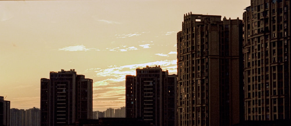 a plane flying over a city with tall buildings