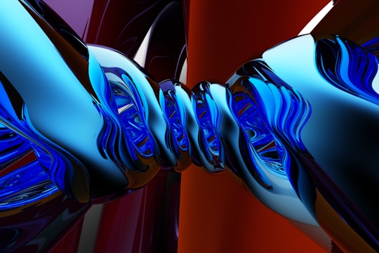 A digital abstract artwork featuring twisted and interwoven metallic structures. The smooth and reflective surfaces have a blend of vibrant blue and purple colors, set against a backdrop of deep red and black tones, creating a dynamic and fluid composition.