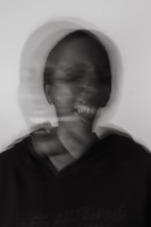 a blurry photo of a man brushing his teeth