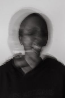 a blurry photo of a man brushing his teeth