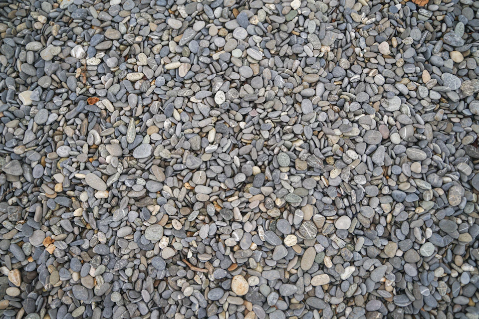 Close-up view of rocky surface composed of small, gray rocks scattered across frame
