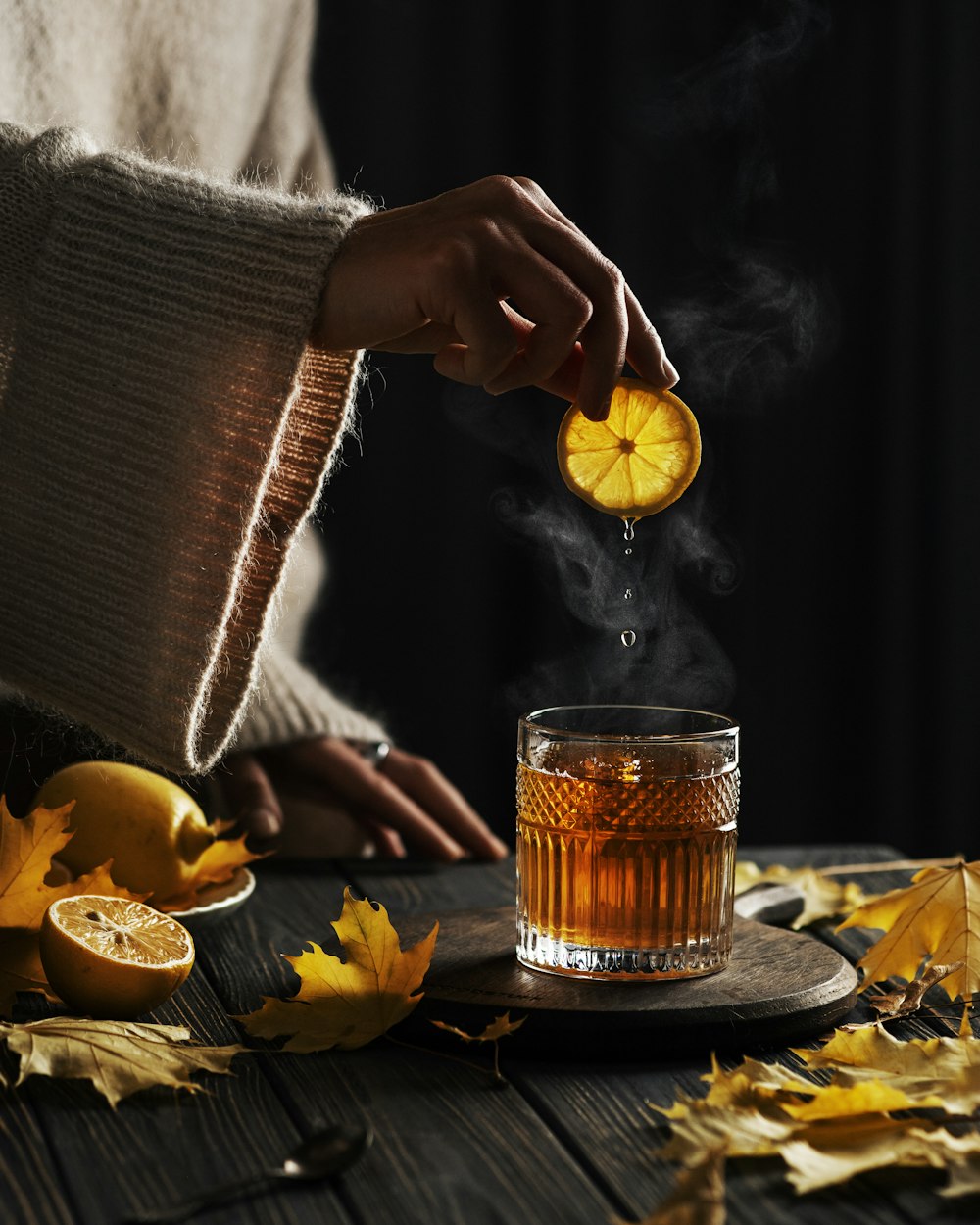 a person pouring a drink into a glass