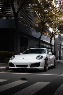 A sleek, modern driving school car parked on a clean urban street with soft morning light.