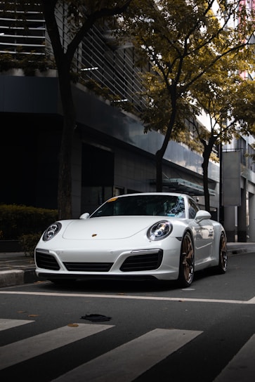 A sleek Japanese import car parked on a scenic UK street under soft daylight.