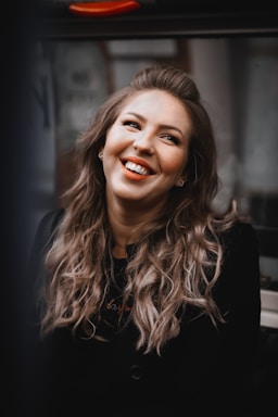 Woman with flowing hair and joyful expression in studio