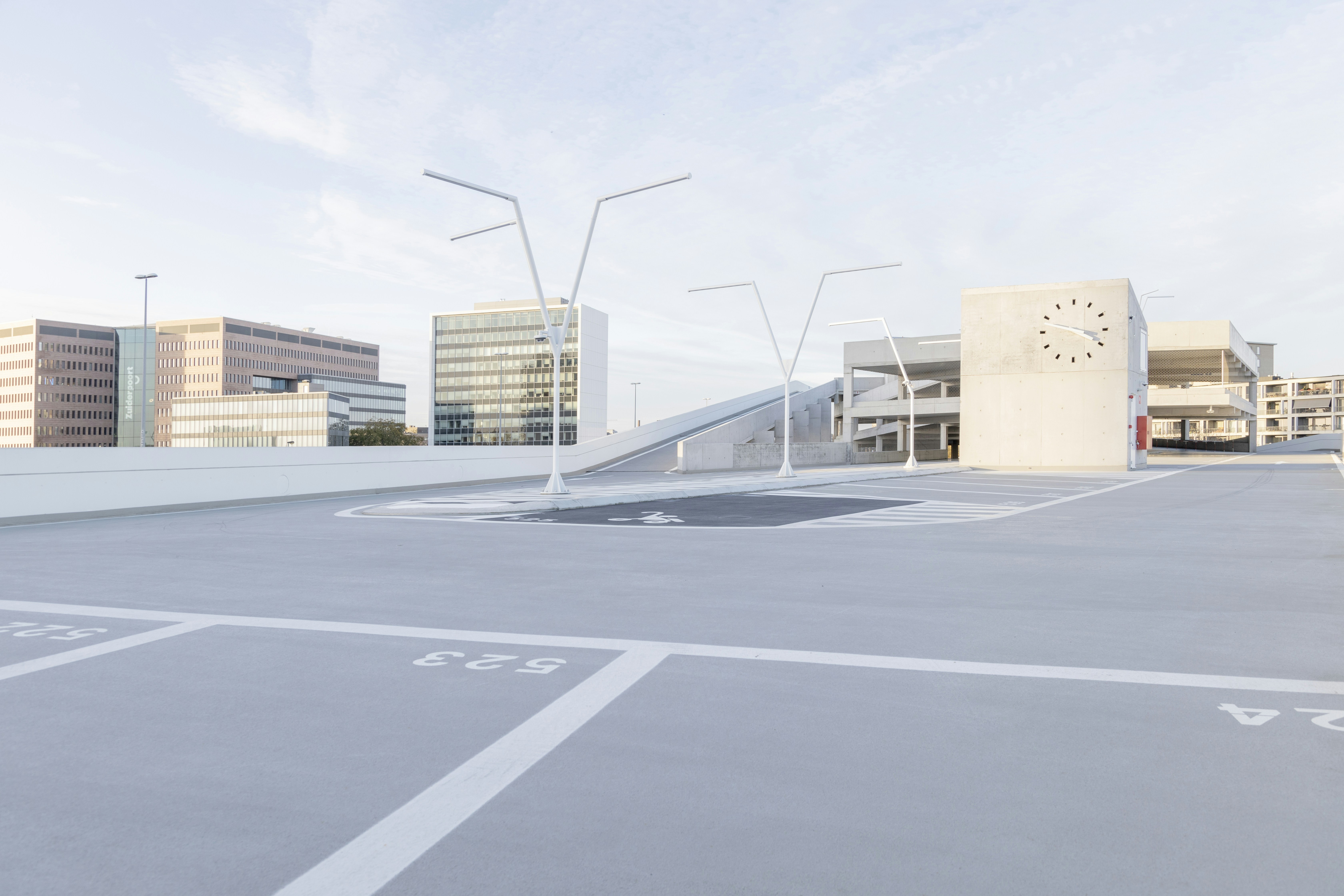 a parking lot with a clock on the side of it