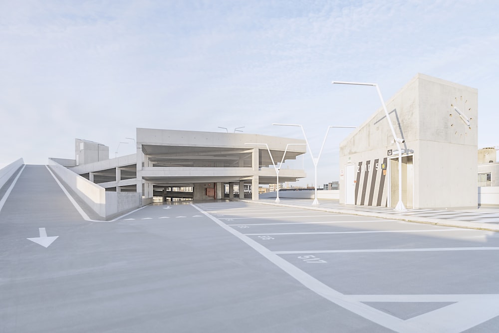 an empty parking lot with a building in the background