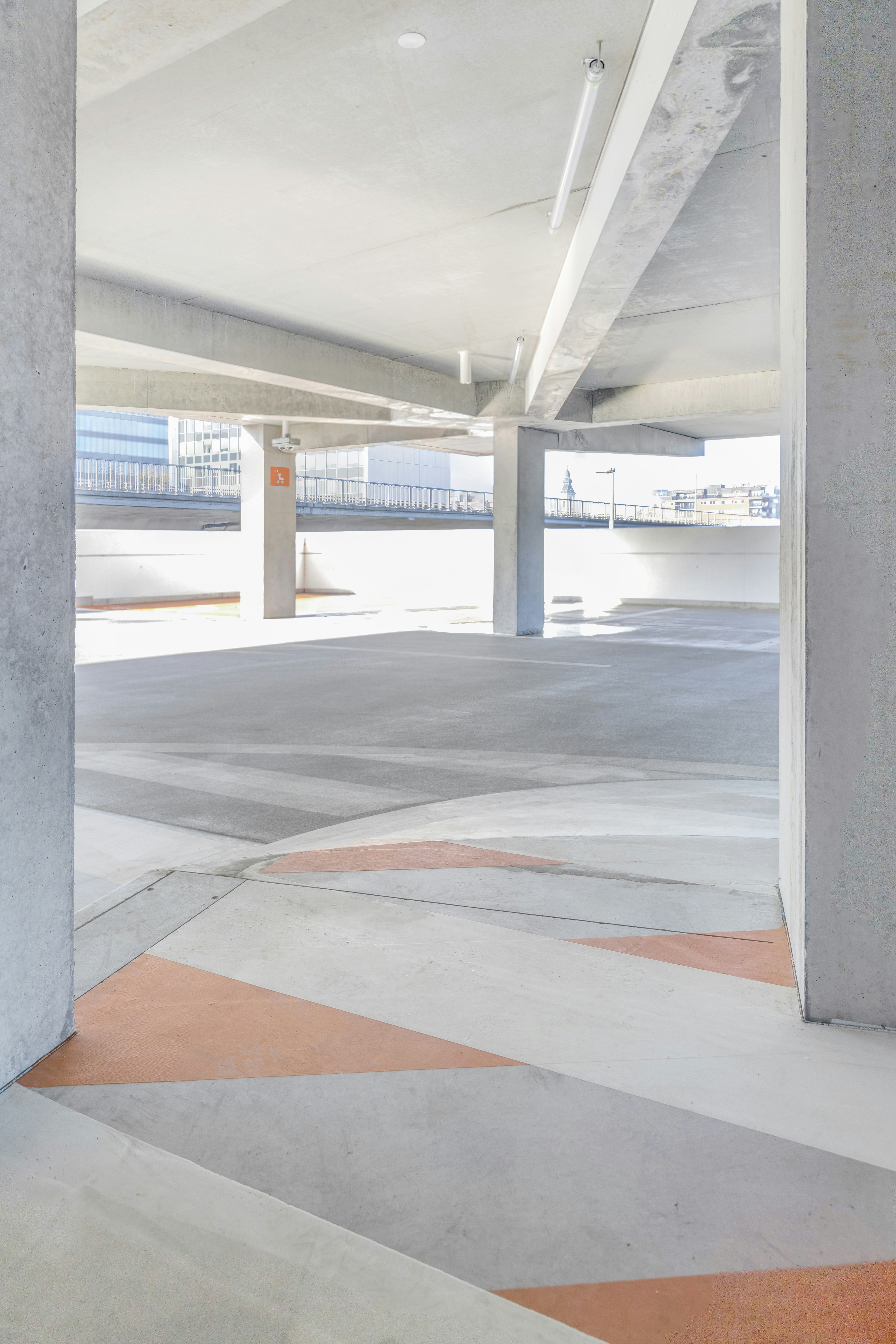 an empty parking garage with a red fire hydrant