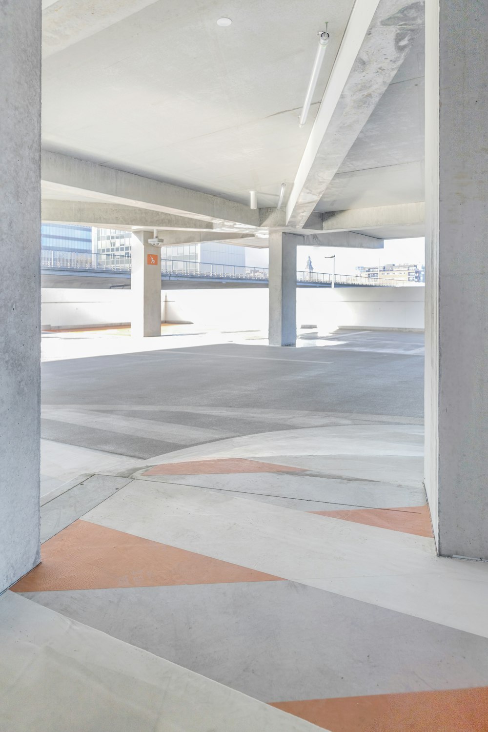 an empty parking garage with a red fire hydrant