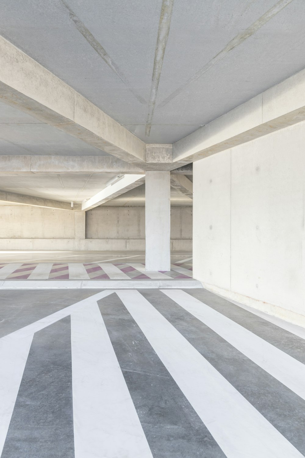 an empty parking garage with striped flooring