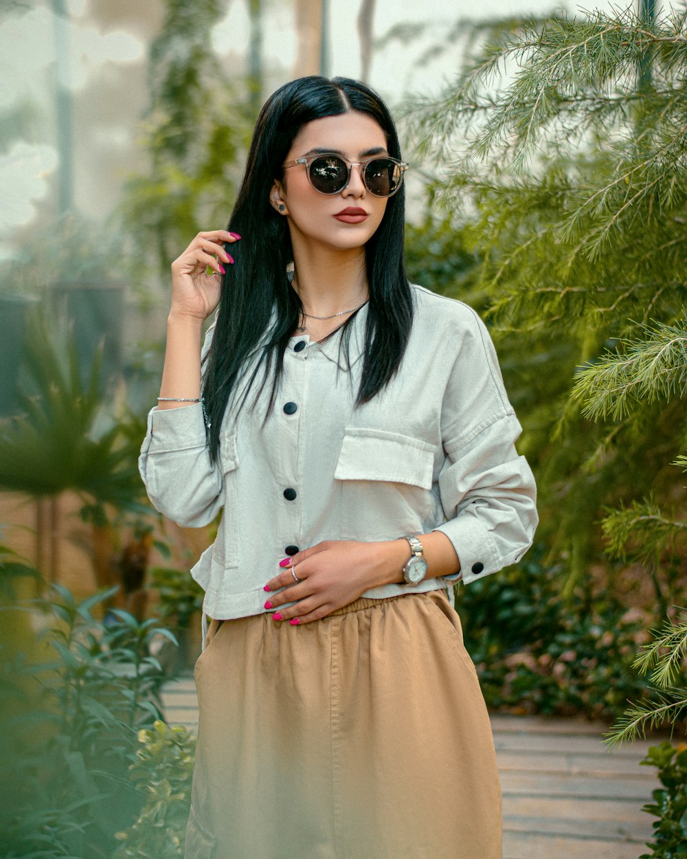 a woman in a white shirt and tan skirt